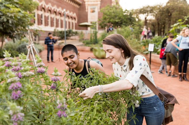 Women smelling herbs in the Nature Garden