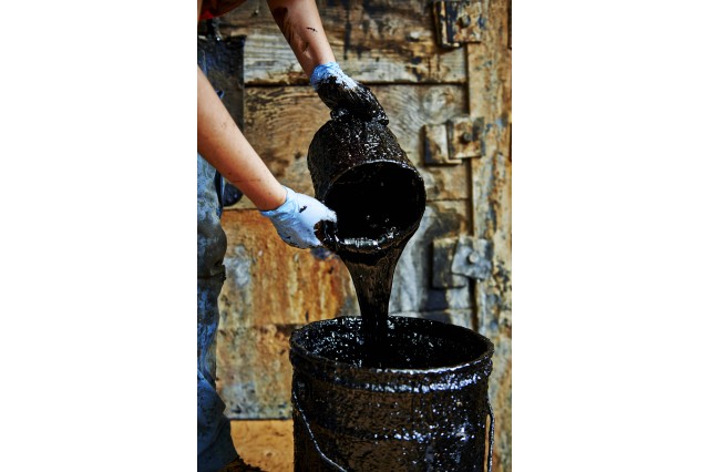 Photograph of &quot;tar&quot; being poured from a bucket