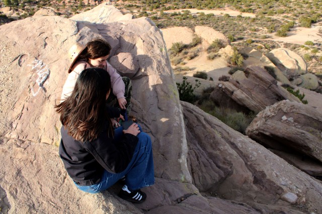 Two people sitting on rock