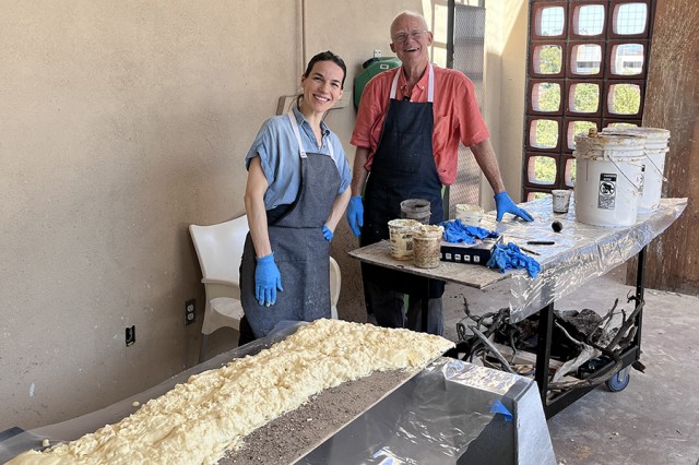 Lauren Schoth and Tim Bovard standing at tables with sculpture materials