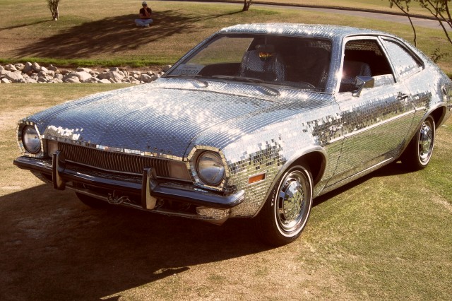 1971 Pinto covered in a mosaic of small mirror tiles to look like a disco ball in car form.