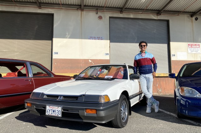 Young man standing next to his car, a white 1987 Honda Prelude