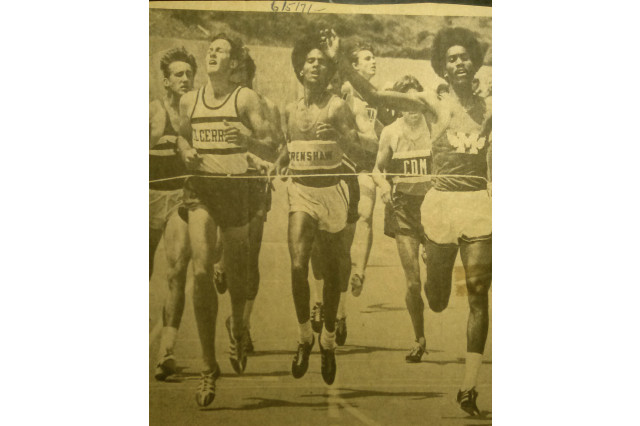 A group of about 10 high school youth are pictured running across a finish line with Purcell Keeling at the front