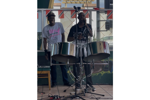 A Band plays instruments on the patio of Simply Wholesome