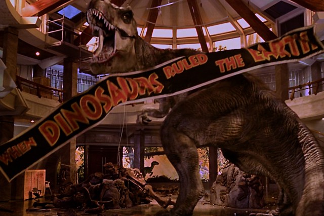 Black and orange banner in front of a dinosaur