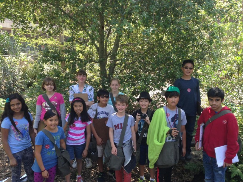 Nature Navigators 2015 class posing for a photo after checking their camera trap in NHM Nature Gardens.